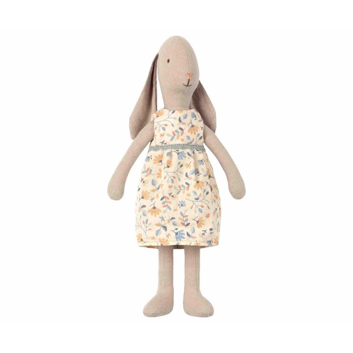 10 inch tall plush bunny stuffed animal wearing yellow dress with blue and peach flowers. Made of cotton muslin fabric.